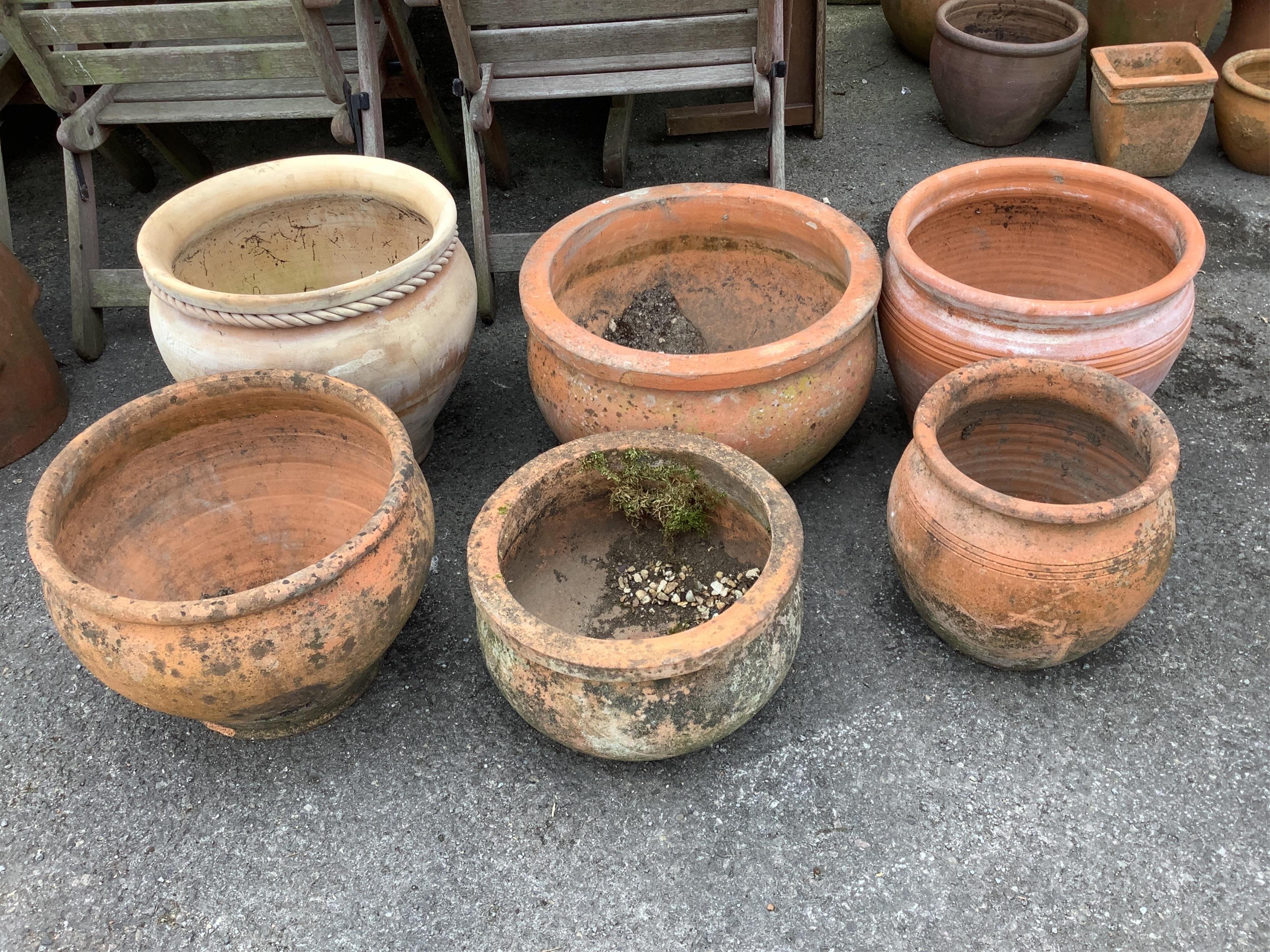 Six circular terracotta garden planters, largest diameter 51cm, height 30cm